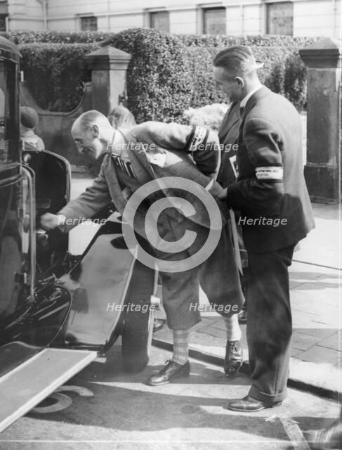 A judge inspecting a car at the Southport Rally, 1928. Artist: Unknown