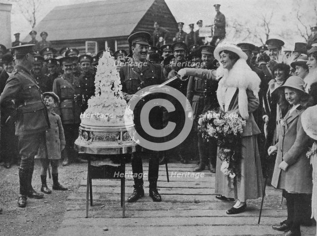 'A khaki wedding: Cutting the wedding cake with the bridegroom's sword', 1915. Artist: Unknown.