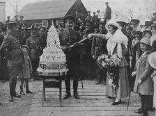 A khaki wedding: Cutting the wedding cake with the bridegroom's sword 1915