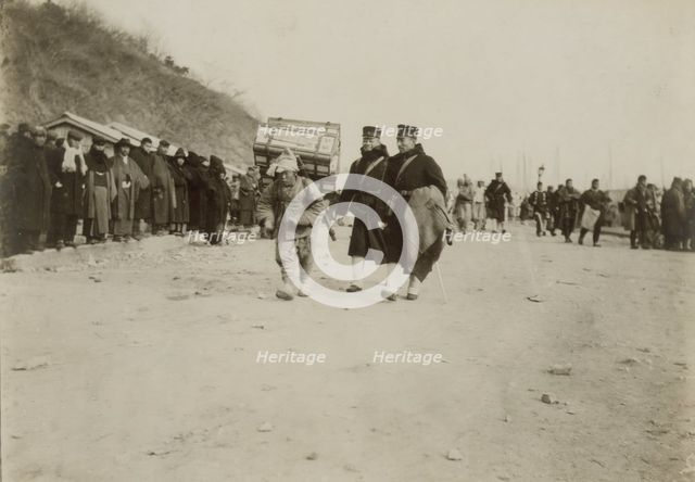 A Korean coolie carrying medical supplies from shore to hospital at Chemulpo, c1904. Creator: Robert Lee Dunn.