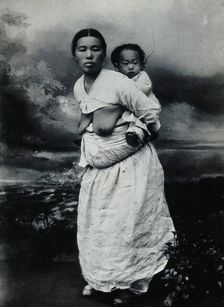 A Korean (?) woman, carrying a baby on her back, approx 1900. Creator: Unknown