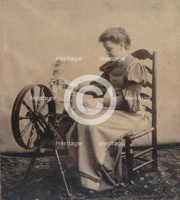 A lady at a spinning wheel c1900. Artist: Unknown