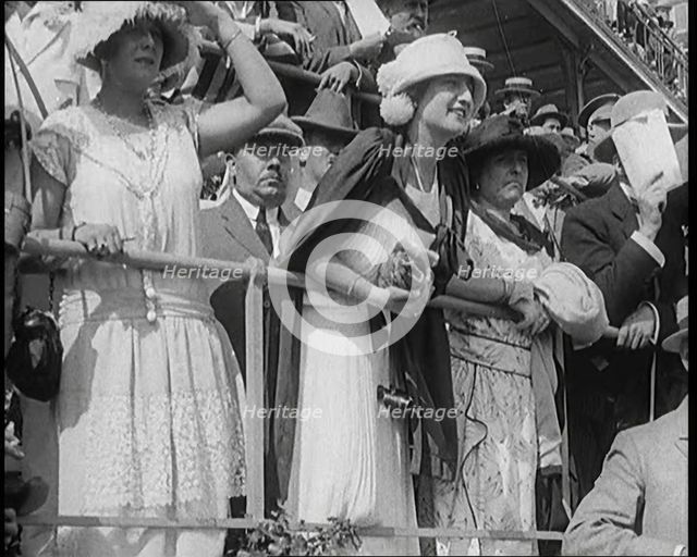 A Large Crowd of Civilians Wearing Smart Outfits and Hats Watching a Horse Race, 1920. Creator: British Pathe Ltd.