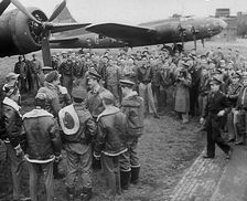 A Large Group of American Pilots Standing Below a Bomber Aircraft. Several Pilots are..., 1943-1944. Creator: British Pathe Ltd