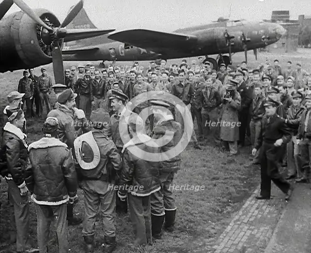 A Large Group of American Pilots Standing Below a Bomber Aircraft. Several Pilots are..., 1943-1944. Creator: British Pathe Ltd.