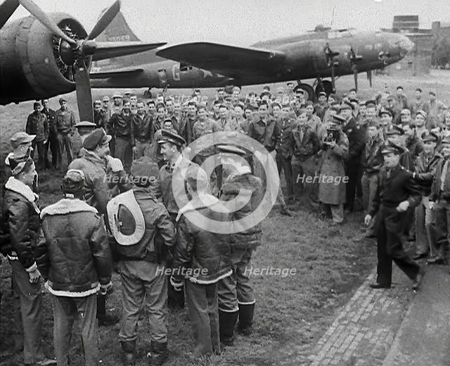 A Large Group of American Pilots Standing Below a Bomber Aircraft. Several Pilots are..., 1943-1944. Creator: British Pathe Ltd.