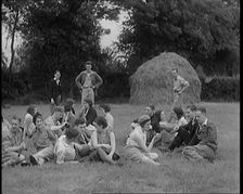 A Large Group of Hikers Having Drinks in a Field Beside a Haystack, 1931. Creator: British Pathe Ltd