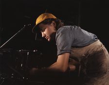 A lathe operator machining parts for...Consolidated Aircraft Corp. plant, Fort Worth, Texas, 1942. Creator: Howard Hollem