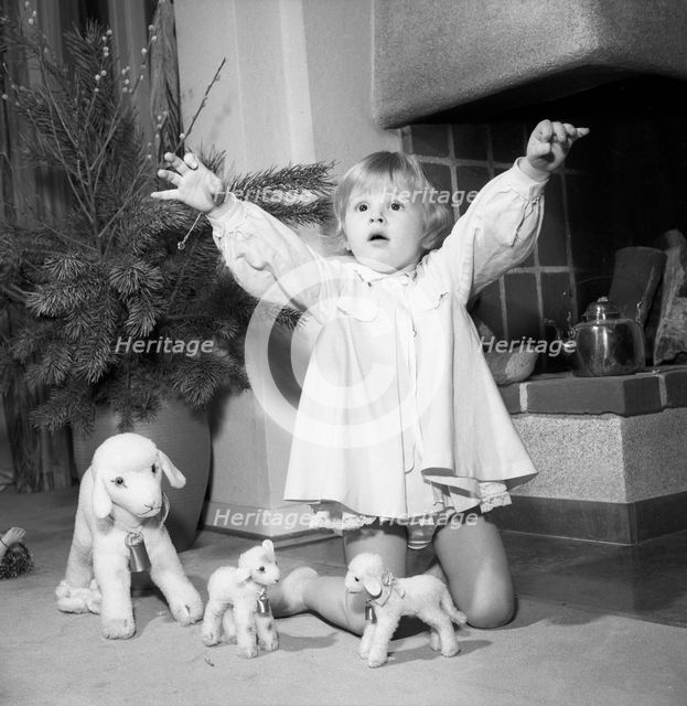 A litte girl playing with her christmas gifts, Sweden, 1955. Creator: Unknown.