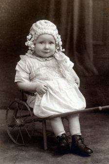 A little girl in a cart, c1910. Creator: Unknown