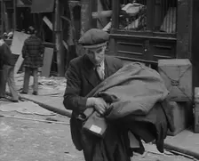 A Man Carrying His Possessions Away, 1940. Creator: British Pathe Ltd