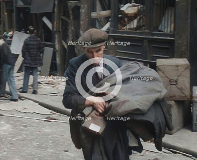 A Man Carrying His Possessions Away, 1940. Creator: British Pathe Ltd.