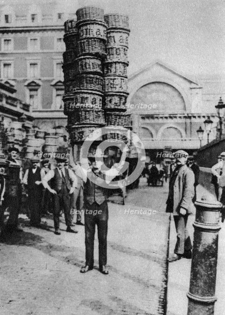 A man carrying many baskets on his head, Covent Garden, London, 1926-1927. Artist: Unknown