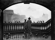 A man and a boy feeding the birds by Blackfriars Bridge, London, 1926-1927