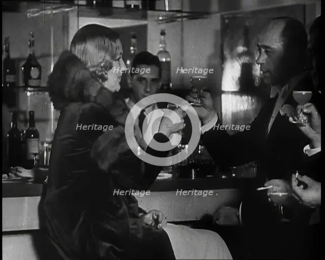 A Man and a Woman Drinking at a Nightclub, 1930s. Creator: British Pathe Ltd.