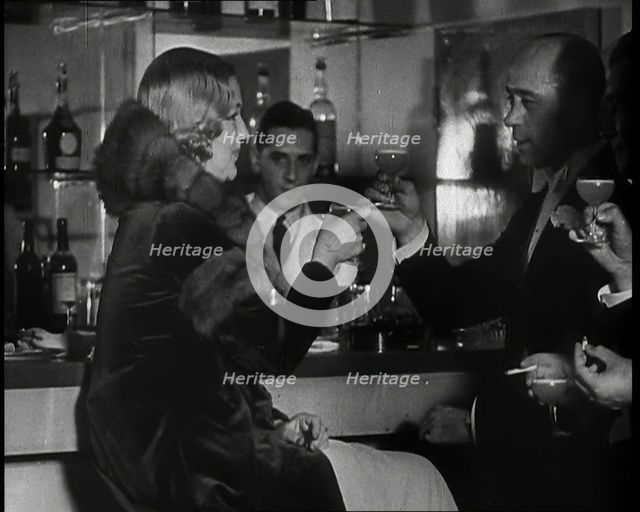 A Man and a Woman Drinking at a Nightclub, 1930s. Creator: British Pathe Ltd.