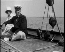 A Man and a Woman Sitting on the Deck of a Yacht at Cowes, 1933. Creator: British Pathe Ltd