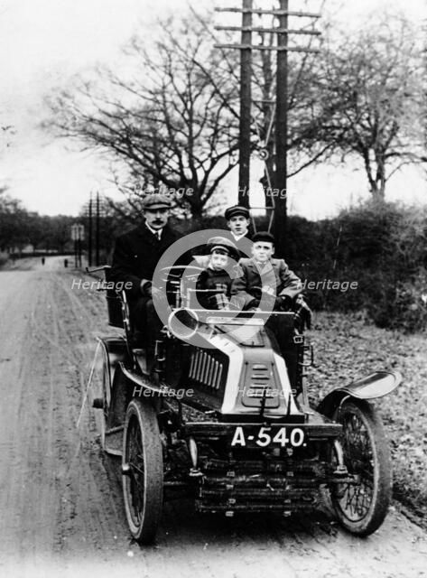 A man and boys in a De Dion car, 1908. Artist: Unknown