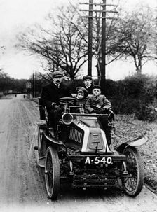 A man and boys in a De Dion car, 1908