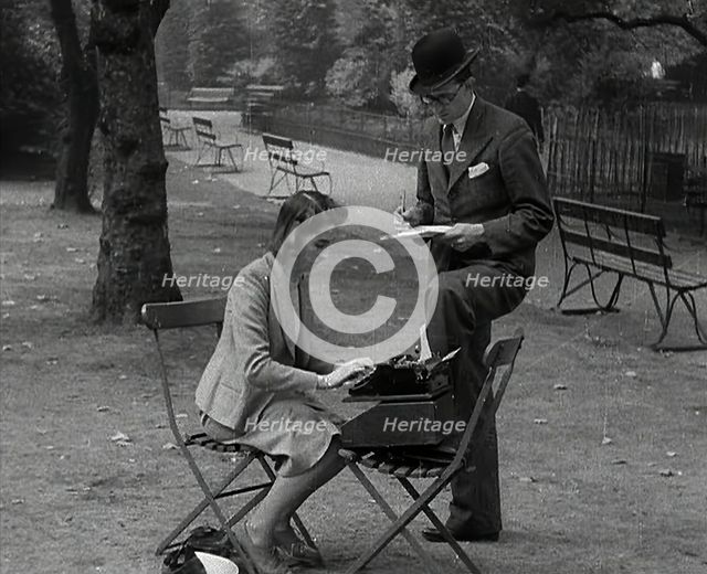 A Man and Woman Taking Notes in a Park, 1941. Creator: British Pathe Ltd.