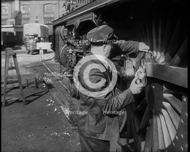 A Man Doing Maintenance Work on a Train Carriage, 1940. Creator: British Pathe Ltd.
