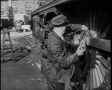 A Man Doing Maintenance Work on a Train Carriage, 1940. Creator: British Pathe Ltd