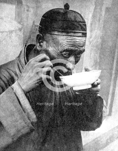A man eating, Mukden (Shenyang), China, 1936.Artist: Wide World Photos