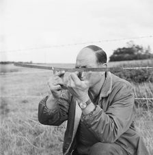 A man holding a surveyor's protractor working on the route of the Mersey oil pipeline, 24/09/1967. Creator: John Laing plc