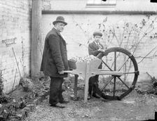 A man holding his potato planting invention, 1900. Artist: Henry Taunt
