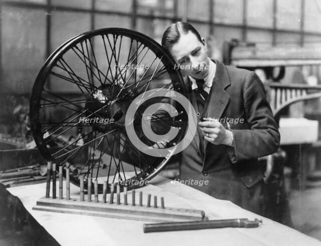 A man in a workshop with a wheel. Artist: Unknown