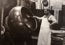 A man in an apron panning chocolate, Rowntree Cocoa Works, York, Yorkshire, 1900