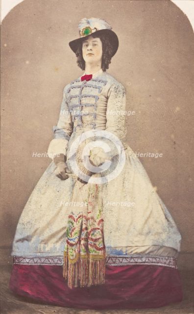 A man in drag wearing an elaborate dress and feathered hat, (20th century?). Creator: Unknown.