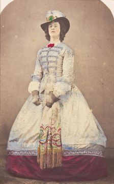 A man in drag wearing an elaborate dress and feathered hat, (20th century?). Creator: Unknown