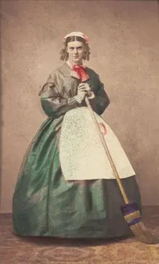 A man in drag holding a broom, 1862. Creator: Unknown