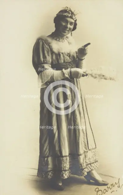 A man in drag, holding a feather, performing in the play 'A country girl', 1920. Creator: Unknown.