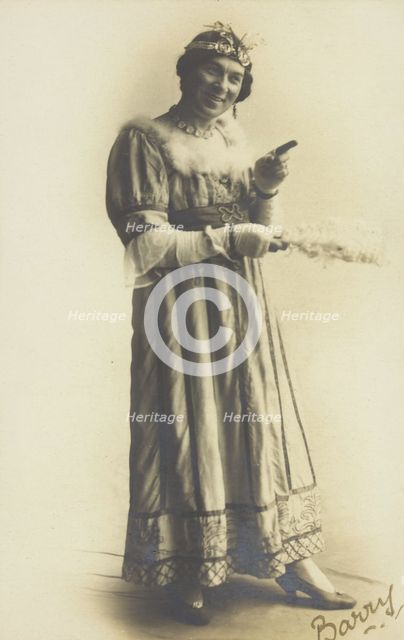 A man in drag, holding a feather, performing in the play 'A country girl', 1920. Creator: Unknown.