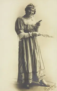 A man in drag, holding a feather, performing in the play A country girl 1920. Creator: Unknown