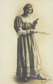 A man in drag, holding a feather, performing in the play A country girl 1920. Creator: Unknown