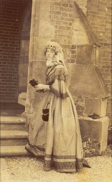 A man in drag posing in historical costume, (between 1890 and 1899?). Creator: Unknown