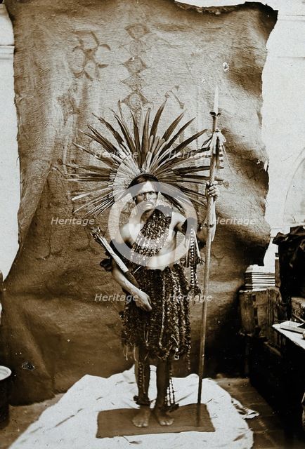A man of an Amazonian tribe, holding a spear and wearing a feathered head-dress, in a..., 1900. Creator: Marc Ferrez.
