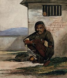 A man of Simla, squatting in a prison with manacles around his ankles, 1866. Creator: R Clint