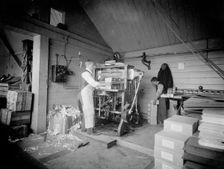 A man operates a printing press at the Church Army Press, Oxford, Oxfordshire, c1860-c1922. Artist: Henry Taunt