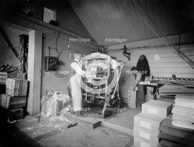 A man operates a printing press at the Church Army Press, Oxford, Oxfordshire, c1860-c1922. Artist: Henry Taunt