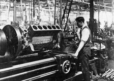 A man operating a jig at the Napier works, July 1920