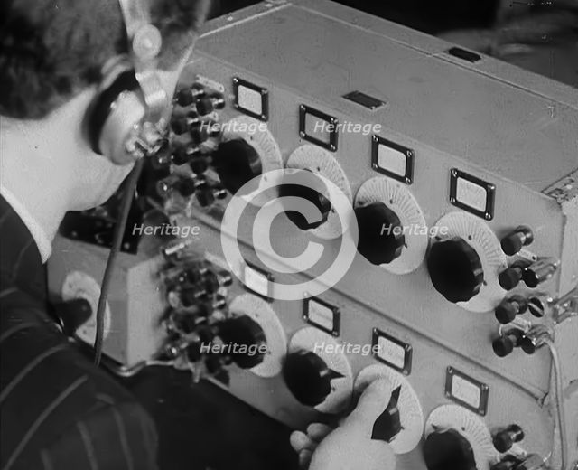 A Man Operating a Radio, 1940. Creator: British Pathe Ltd.