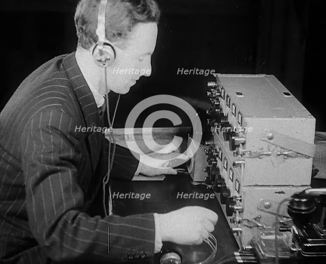 A Man Operating a Radio, 1940. Creator: British Pathe Ltd.