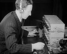 A Man Operating a Radio, 1940. Creator: British Pathe Ltd
