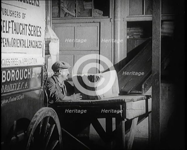 A Man Loading Bundles of Newspapers Into a Van, 1921. Creator: British Pathe Ltd.