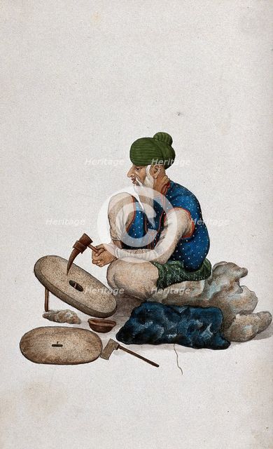 A man making grindstones, (between 1800 and 1899?). Creator: Unknown.
