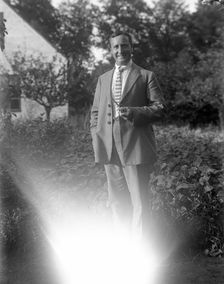 A man smoking his pipe in the garden, Flyinge, Sweden, 1920s. Creator: Unknown
